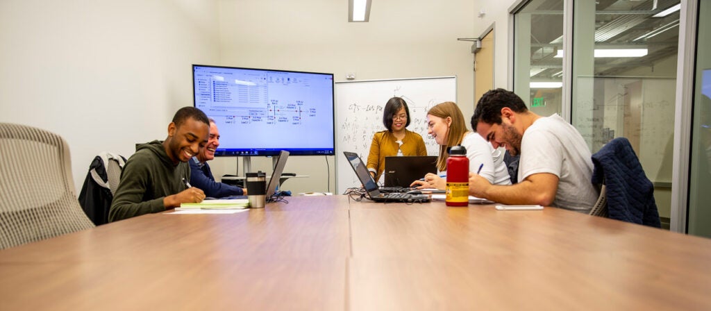 Students studying in conference room.