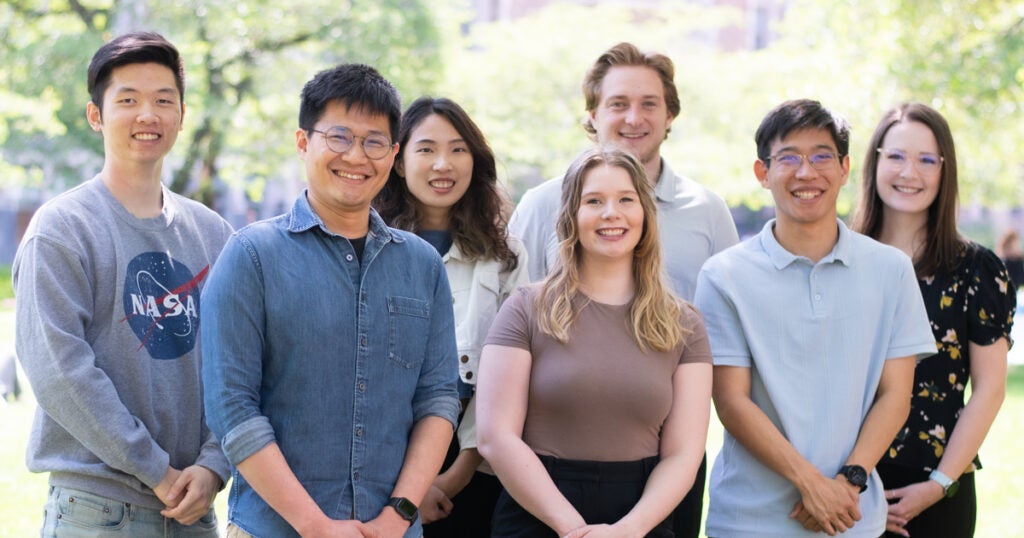 A group of MSIM students stand together outside.
