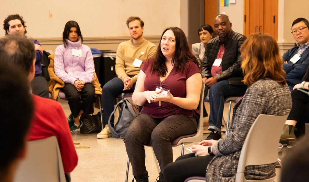 A group of UW MSIM students converse in a classroom setting.