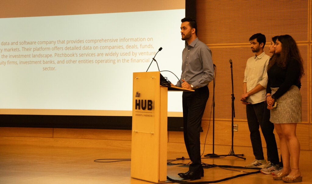 UW MSIM students present at a podium